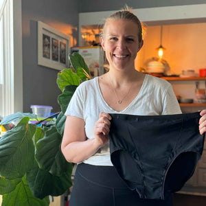 Our founder Lauren Fleming holding the 1.0 version of the Hem Support Wear high waisted garment.