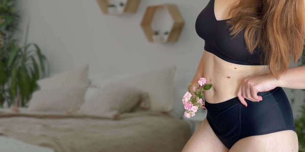 Woman wearing black Hem Support Wear high waisted pelvic floor support—comfortable pelvic floor support that feels as good as it looks.